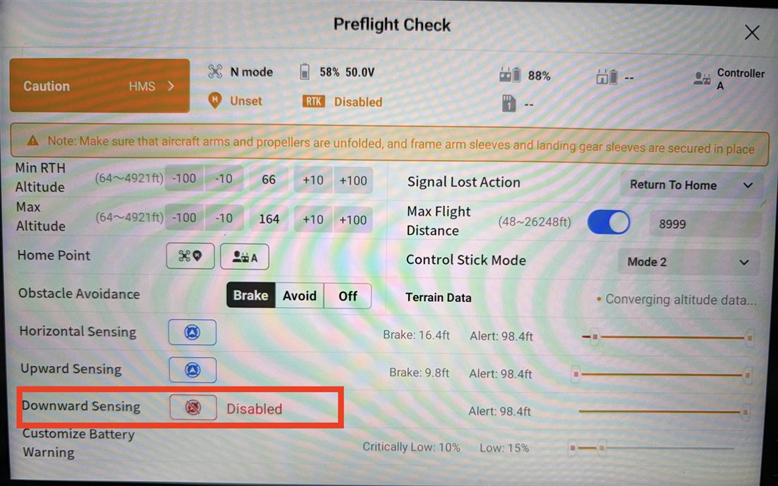 DJI remote controller camera view showing the downward sensor toggle